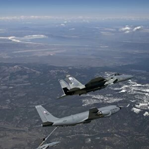 Two F-15 Eagles conduct aerial refueling with a KC-135 Stratotanker