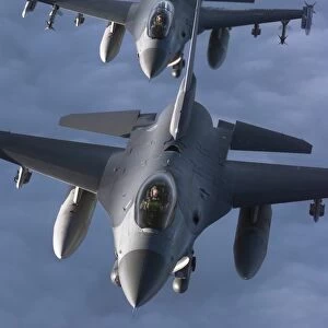 Two F-16 Fighting Falcons fly in formation