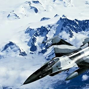 An F-16C Falcon from the 18th Aggressor Squadron flies over an Alaskan mountain range