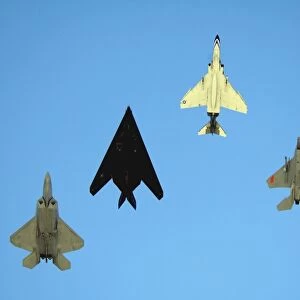 An F-22 Raptor, an F-117 Nighthawk, an F-4 Phantom and an F-15 Eagle in flight