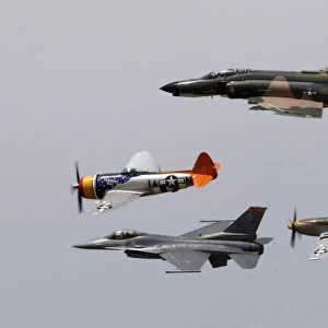 An F-4 Phantom, P-47 Thunderbolt, F-16 Fighting Falcon and P-51 Mustang fly in a