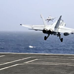 Two F / A-18C Hornet strike fighters launch from the aircraft carrier USS Ronald Reagan