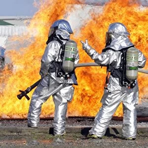 Firefighters battle a simulated fire