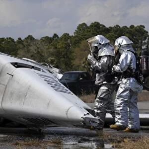 Firefighters respond to the scene of a simulated plane crash
