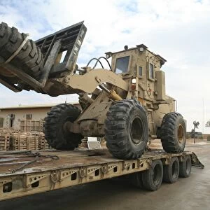 forklift is unloaded off of a logistics support vehicle