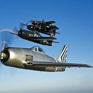 Two Grumman F8F Bearcats and two F7F Tigercats fly in formation