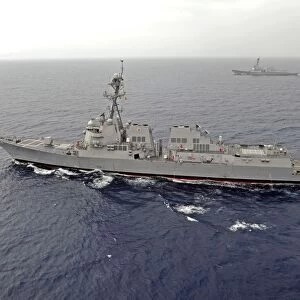Guided missile destroyers USS Dewey and USS Pinckney transit the South China Sea