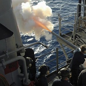 Gunners Mates fire the. 40mm saluting battery aboard USS Bataan