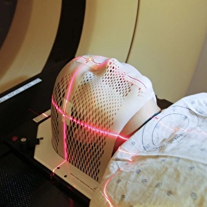 Lasers used to position a patient wearing a short face mask in a computed tomography