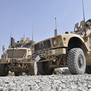 An M-ATV Mine Resistant Ambush Protected vehicle parked next to a MaxxPro MRAP