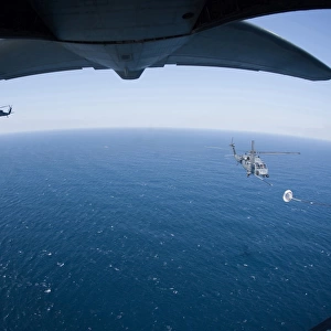 An MC-130P Combat Shadow prepares to refuel two HH-60G Pave Hawk helicopters