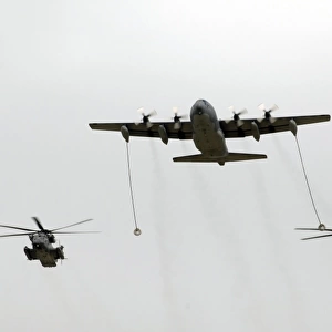 A MC-130W conducts an in-flight refueling for two MH-53J Pave Low III helicopters