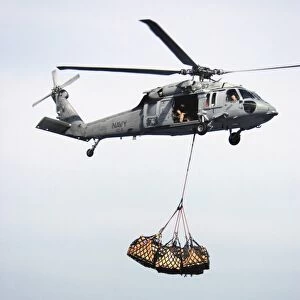 An MH-60S Knighthawk delivering cargo