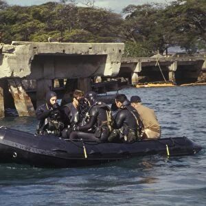 Navy Seals combat swimmers sitting in a combat rubber raiding craft, Oahu, Hawaii