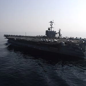 The Nimitz-class aircraft carrier USS John C. Stennis transits the Arabian Gulf