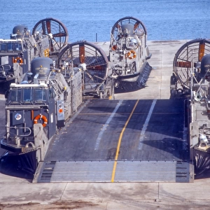 A pair of Navy landing craft air cushions rest on the old World War II seaplane ramps