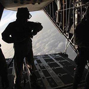 Pararescuemen prepare for a HALO jump aboard an HC-130 over Djibouti