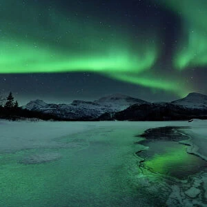 Reflected aurora over a frozen Laksa Lake, Nordland, Norway