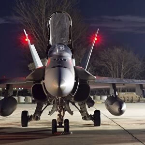 A Royal Canadian Air Force CF-188 Hornet preparing for a night takeoff from Romania