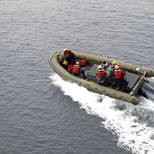 Sailors in a rigid-hull inflatable boat conduct boat operations