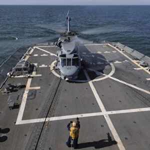 An SH-60B Sea Hawk lands on the flight deck of USS Forrest Sherman