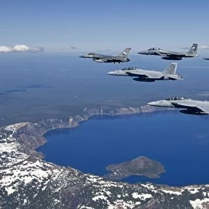A five ship aircraft formation flies over Crater Lake, Oregon