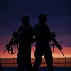 Silhouette of U.s Marines on a bunker at sunset in Afghanistan
