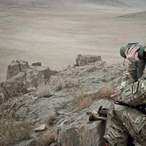 A soldier watches the impact area during a live fire exercise in Afghanistan