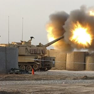 Soldiers fire the howitzers on their M109A6 Paladins