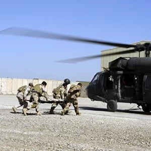 Soldiers rush a simulated casualty to a UH-60 Blackhawk helicopter