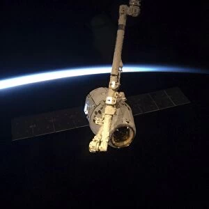 The SpaceX Dragon cargo craft with Earths horizon in the background
