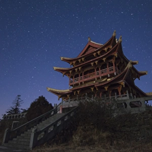 Stars of the Big Dipper and constellation Leo shine above a temple of Mount Emei in China