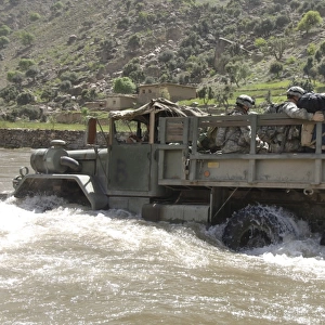 A truck full of U. S. Army soldiers fording the Pech River in Pech Valley, Afghanistan