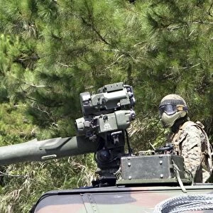 A tube-launched, optically-tracked, wire-guided missile gunner scans for threats