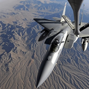 A U. S. Air Force F-15 Eagle flies toward the boom of a KC-135 Stratotanker