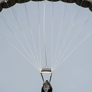 A U. S. Air Force pararescueman descends during jump training