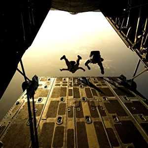 U. S. Air Force pararescuemen jump from an HC-130 aircraft off the coast of Djibouti