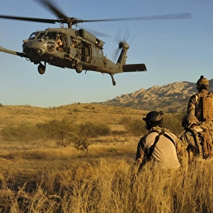 U. S. Air Force pararescuemen signal in a HH-60 Pave Hawk for extraction