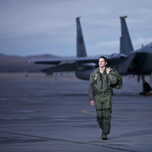 A U. S. Air Force pilot walking away from a F-15C Eagle