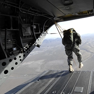 U. S. Airmen jump from a CH-47 Chinook over Nevada