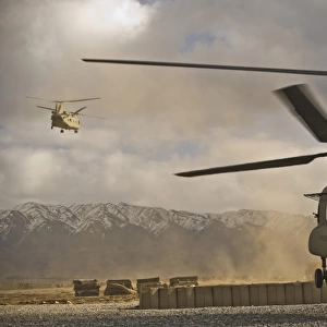 U. S. Army CH-47 Chinook helicopters depart a military base in Afghanistan