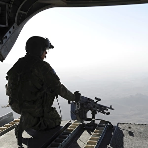 A U. S. Army soldier scans the area in the back of a CH-47 Chinook over Afghanistan