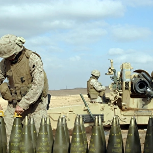 A U. S. Marine prepares howitzer rounds to be fired near Baghdad, Iraq