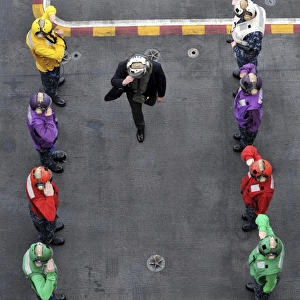 U. S. Navy rainbow sideboys stationed aboard aircraft carrier USS Abraham Lincoln