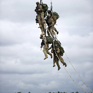 U. S. Soldiers are lifted off the ground by a CH-47 Chinook helicopter
