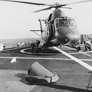 A UH-2 Seasprite helicopter lands aboard USS Coontz, 1969