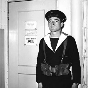 A French sentry outside the operations room of the aircraft carrier La Fayette, 1951