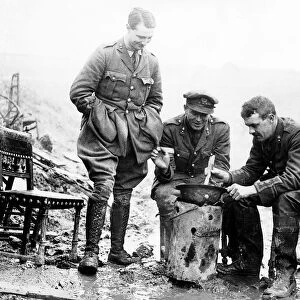 British officers cook a casserole in an army helmet 1917 during World War One