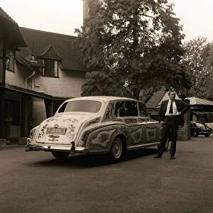 The chauffeur of The Beatles singer John Lennon standing beside Lennon