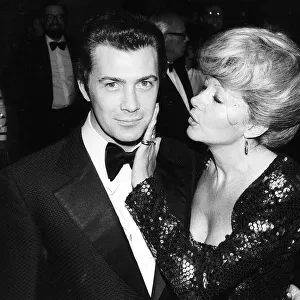 Lewis Collins Actor has his face caressed by Ingrid Pitt at the premiere of his film